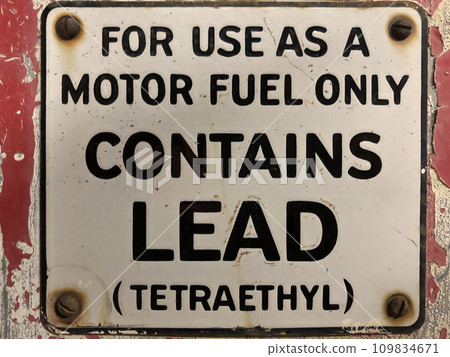 Vintage gas pump leaded tetraethyl sign. rusty with background peeling red paint. Concept for environmental awareness, green movement and global warming. Quality photo 109834671
