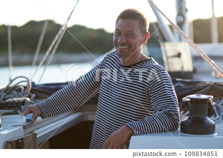 Smiling man in a striped thsirt on ayacht 109834851