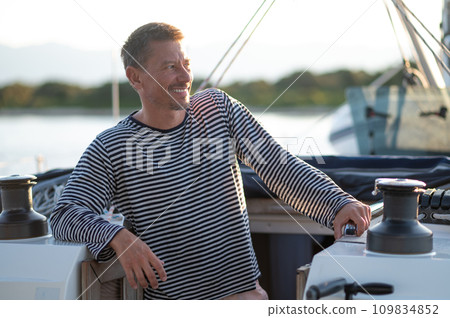 Smiling man in a striped thsirt on ayacht 109834852