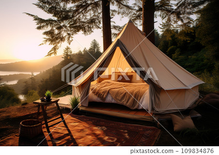 Sunset glamping in a forest, with a luxury tent perched above a stunning valley view, inviting relaxation. Camping with luxury, plush bedding, and nature's beauty. Generative AI. 109834876