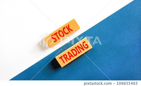 Stock trading symbol. Concept words Stock trading on beautiful wooden blocks. Beautiful white and blue background. Business stock trading concept. Copy space. Stock trading symbol. Concept words Stock trading on beautiful wooden blocks. Beautiful white and blue background. Business stock trading concept. Copy space. 109835483