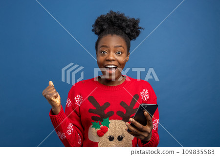 Young woman with a phone in hands feeling excited 109835583