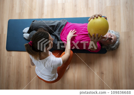 Physiotherapist working with a senior man helping him to rehabilitate and stay active 109836688