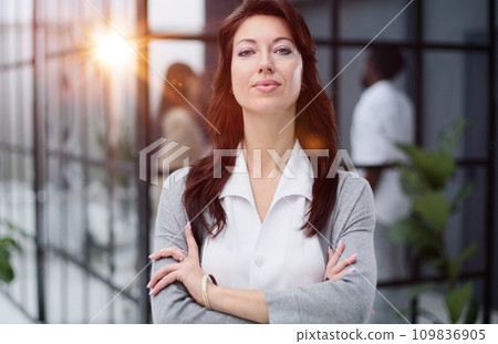 Confident young woman in a closed pose. Office professions Confident young woman in a closed pose. Office professions 109836905