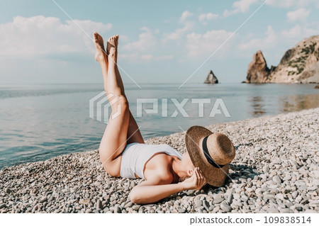 Woman white bikini beach tan. Happy woman in swimwear and hat on vacation. Summer travel holidays vacation on the sea Woman white bikini beach tan. Happy woman in swimwear and hat on vacation. Summer travel holidays vacation on the sea 109838514