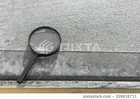 Concrete and magnifying glass before hardening Concrete and magnifying glass before hardening 109838711