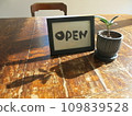 "OPEN" Landscape with books Postcard stand 109839528