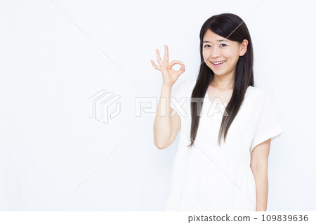 A woman in her thirties signing OK 109839636