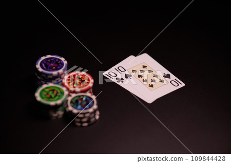 The interior of the casino. Playing cards close-up at the poker table combination of cards a pair of tens. The interior of the casino. Playing cards close-up at the poker table combination of cards a pair of tens. 109844428