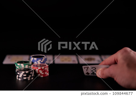 Dealer or croupier shuffles poker cards in a casino on the background of a table, chips. Concept of poker game, game business. Playing for money, a big win, a jackpot, gambling, a desire to get rich. Dealer or croupier shuffles poker cards in a casino on the background of a table, chips. Concept of poker game, game business. Playing for money, a big win, a jackpot, gambling, a desire to get rich. 109844677
