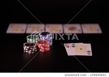 Dealer or croupier shuffles poker cards in a casino on the background of a table, chips. Concept of poker game, game business. Playing for money, a big win, a jackpot, gambling, a desire to get rich.	 109844691