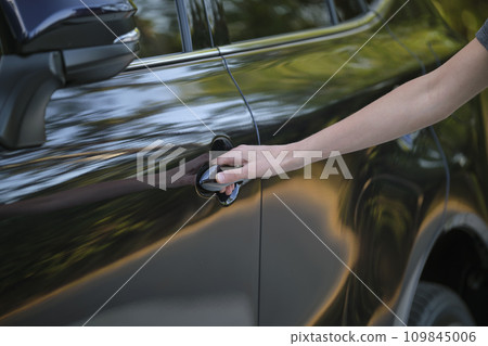 Closeup of driver hand opening car front door Closeup of driver hand opening car front door 109845006