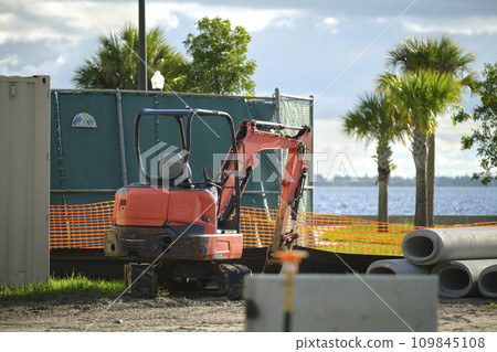 Restriction plastic mesh fence at industrial construction site. Protective barrier for pedestrians safety Restriction plastic mesh fence at industrial construction site. Protective barrier for pedestrians safety 109845108