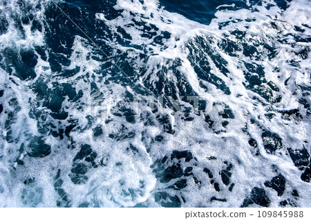 Top down aerial view of sea water surface. White foam waves texture as natural background. Top down aerial view of sea water surface. White foam waves texture as natural background. 109845988
