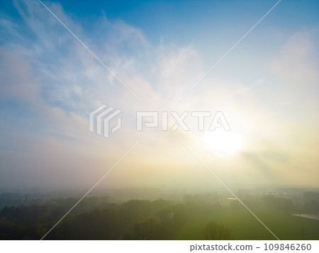 Soft Dawn Light Over a Hazy Countryside 109846260