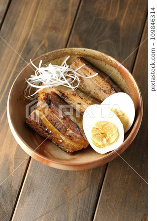 An overhead shot of thickly sliced char siu topped with white onion and boiled egg An overhead shot of thickly sliced char siu topped with white onion and boiled egg 109846314