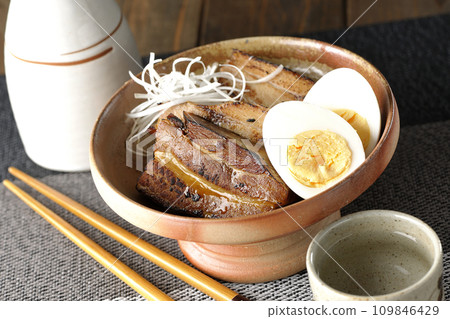 Thickly sliced char siu topped with white onion, boiled egg, and sake Thickly sliced char siu topped with white onion, boiled egg, and sake 109846429