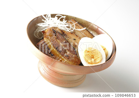 Thickly sliced char siu topped with white onion and boiled egg photographed against a white background Thickly sliced char siu topped with white onion and boiled egg photographed against a white background 109846653