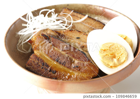 Thickly sliced char siu topped with white onion and boiled egg photographed against a white background Thickly sliced char siu topped with white onion and boiled egg photographed against a white background 109846659