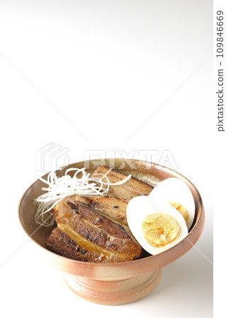 Thickly sliced char siu topped with white onion and boiled egg photographed against a white background 109846669