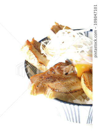 Thick-sliced char siu bowl topped with a soft-boiled egg photographed against a white background 109847101