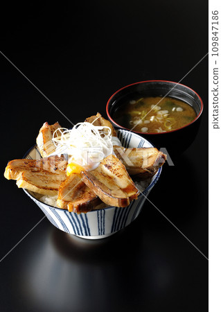 Thick-sliced roasted pork bowl topped with soft-boiled egg and miso soup Thick-sliced roasted pork bowl topped with soft-boiled egg and miso soup 109847186