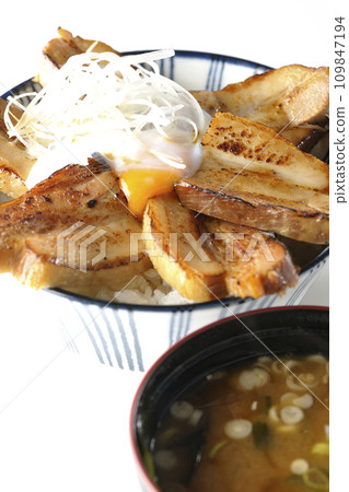 Thick-sliced roasted pork bowl topped with soft-boiled egg and miso soup 109847194