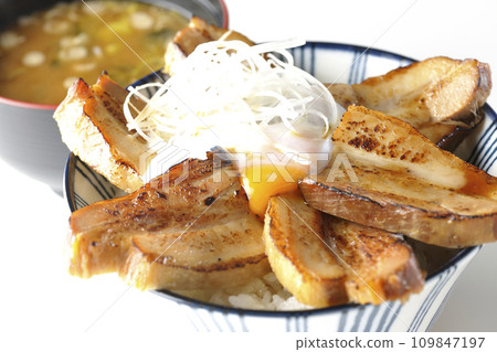 Thick-sliced roasted pork bowl topped with soft-boiled egg and miso soup 109847197