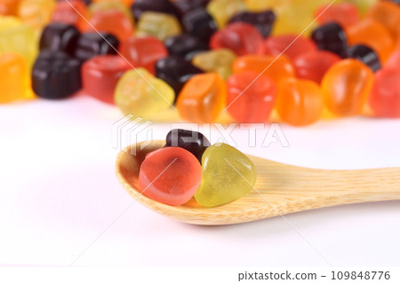 Fruit gummy bears and wooden spoon 109848776