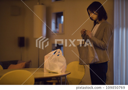 Night routine of a business woman putting ingredients on the table Night routine of a business woman putting ingredients on the table 109850769