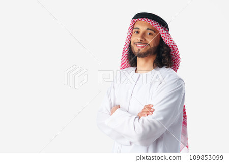 Portrait of a young Arab man wearing middle-eastern traditional dress thobe isolated on white 109853099
