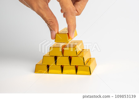 Financial wealth, investment and trading concept.gold bars or gold ingot stacking with business hand. Financial wealth, investment and trading concept.gold bars or gold ingot stacking with business hand. 109853139
