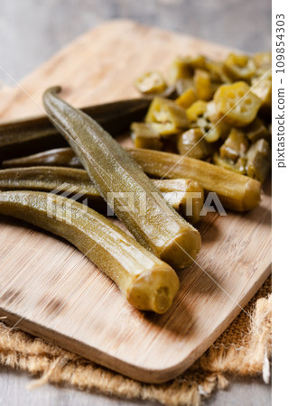 Okra slices on wooden table Okra slices on wooden table 109854303