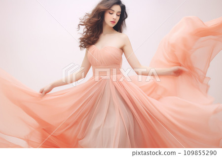 Beautiful young woman in evening dress peach fuzz color of the year 2024 109855290