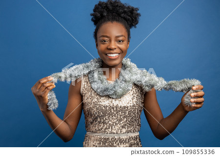 Smiling woman in golden dress and with a necklet looking enjoyed 109855336