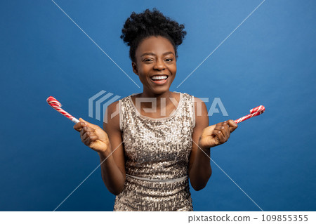 Smiling cute woman with christmas lollipops in hands 109855355