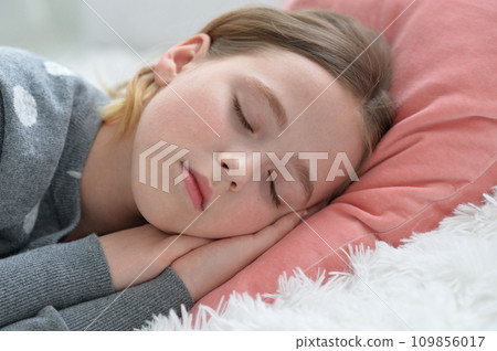 Sweet little girl sleeping in a bed Sweet little girl sleeping in a bed 109856017