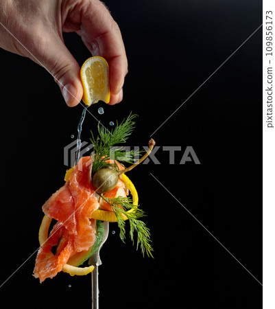 Smoked salmon with dill, cucumber, and capers sprinkled with lemon juice. Smoked salmon with dill, cucumber, and capers sprinkled with lemon juice. 109856173