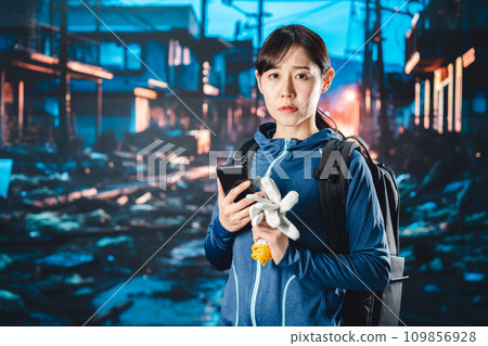 A woman evacuating after a disaster occurs A woman evacuating after a disaster occurs 109856928