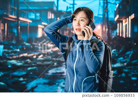 A woman evacuating after a disaster occurs 109856933