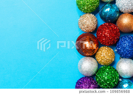 Festive composition of decorative baubles on colorful background. Top view of Christmas toys with copy space 109856988