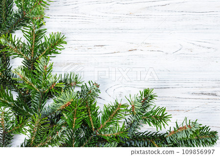 Christmas fir tree with decoration on a wooden board 109856997