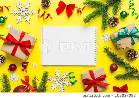 Christmas blank greeting card mock-up scene. Creative layout made of Christmas tree branches and paper card note. Flat lay. Nature New Year concept 109857098