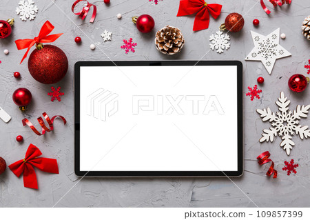 Top view of empty tablet on Christmas background made of new year decorand festive decorations. New year holiday concept. Mockup 109857399