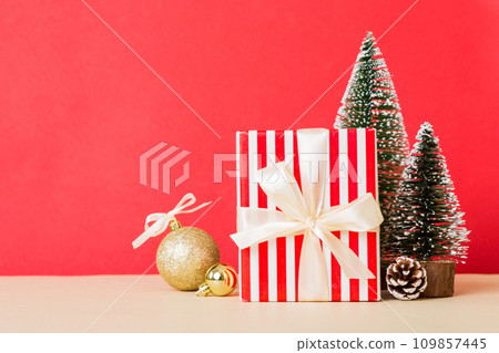 Christmas composition. craft Gift box, small tree, branches and craft DIY decorations on white background. New year concept. Christmas home decoration Flat lay, top view, copy space 109857445