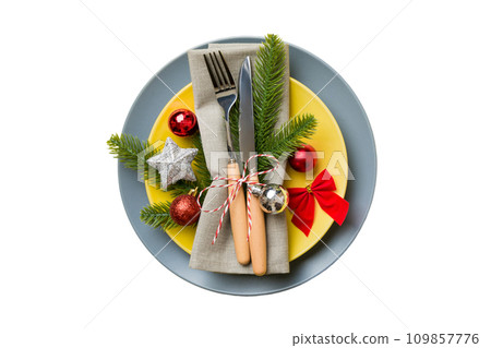 isolated christmas Plate with decor and fork and spoon. New year holiday background. Top view 109857776