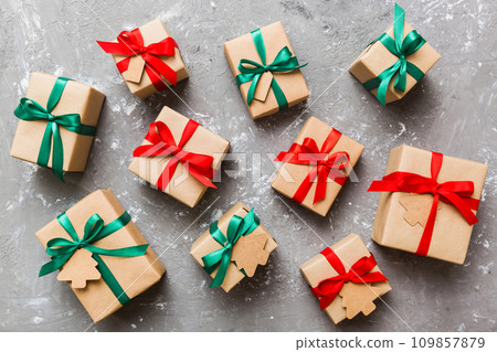Colored craft gift boxes with colorful ribbons on colored background. Collection of Christmas present boxes Colored craft gift boxes with colorful ribbons on colored background. Collection of Christmas present boxes 109857879