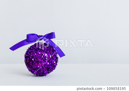 Christmas ball on colored background. decoration bauble with ribbon bow with copy space 109858195