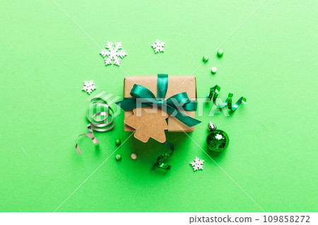 Top view Flat lay Christmas decorations and gift box on colored background with copy space. Christmas or Happy New Year composition Top view Flat lay Christmas decorations and gift box on colored background with copy space. Christmas or Happy New Year composition 109858272