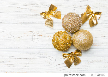 Creative set of New Year baubles and decorations on wooden background. Top view of Christmas time concept. Copy space 109858402